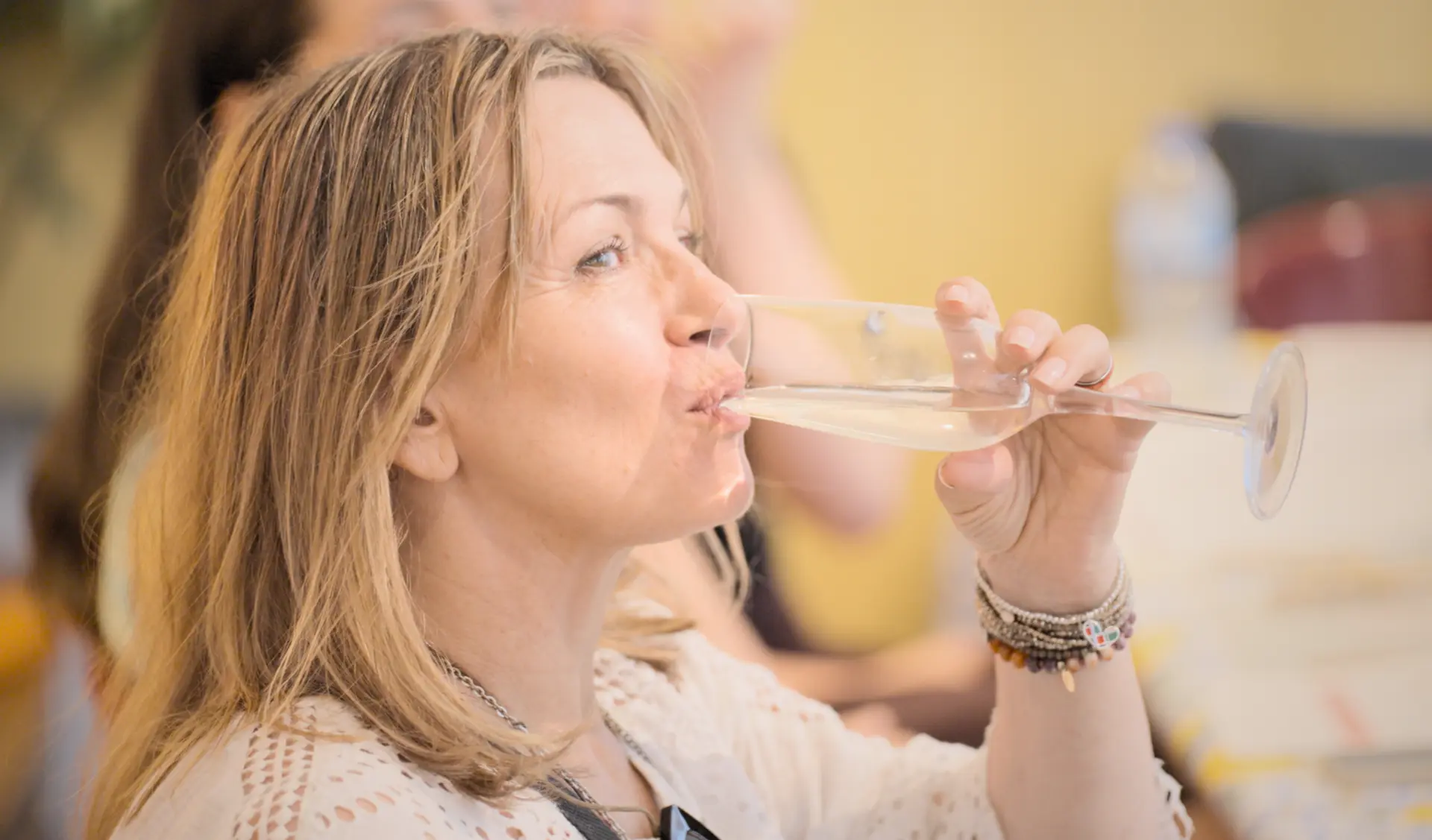 A guest enjoying a glass of sparkling wine at the workshop